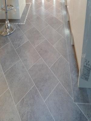 knight tiles cumbrian stone with dark mosiac border laid on the 45° laid by carpetstyle watford 